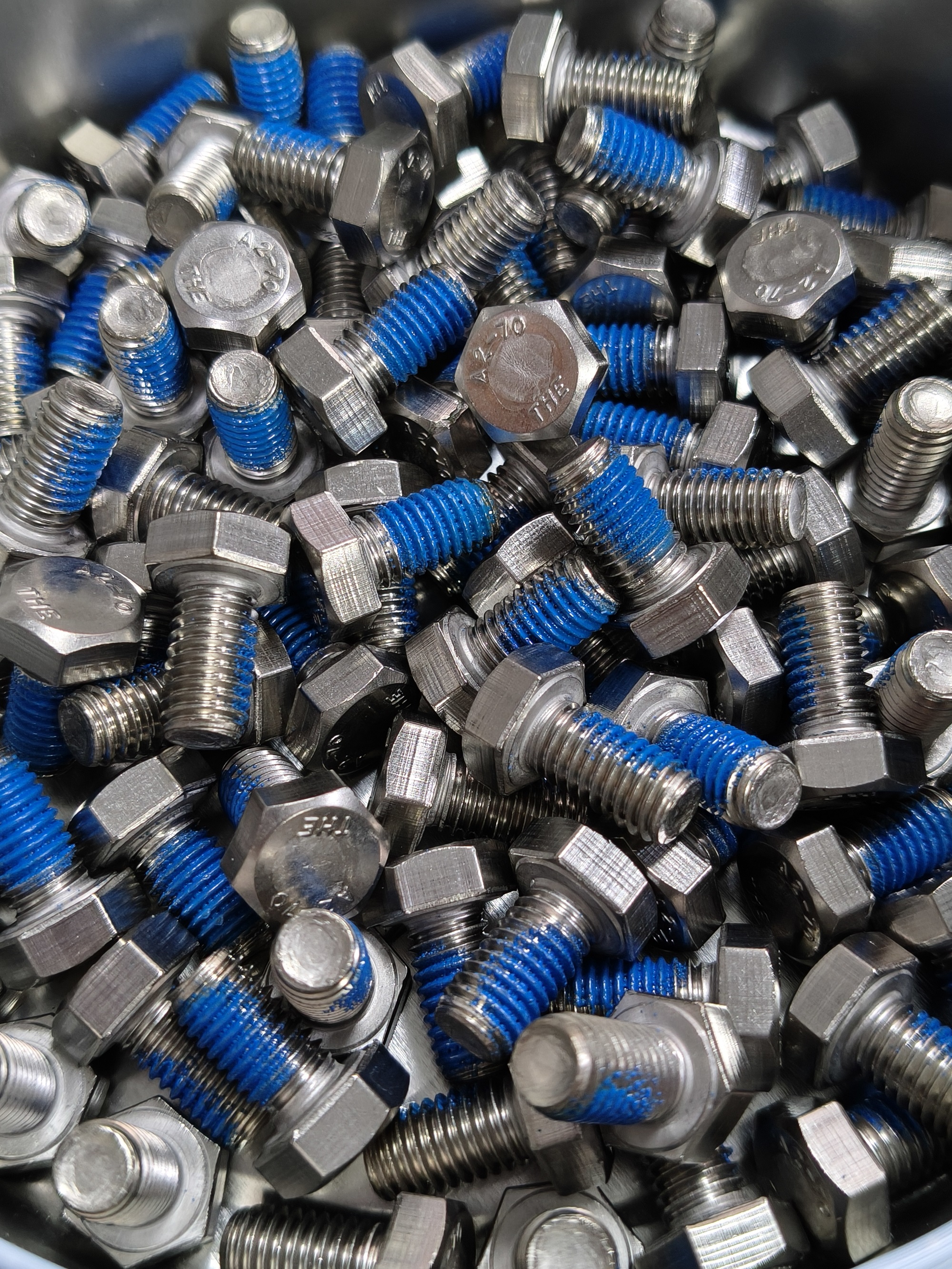 Why are threadlocking adhesives categorized into chemical adhesives and nylon adhesives?